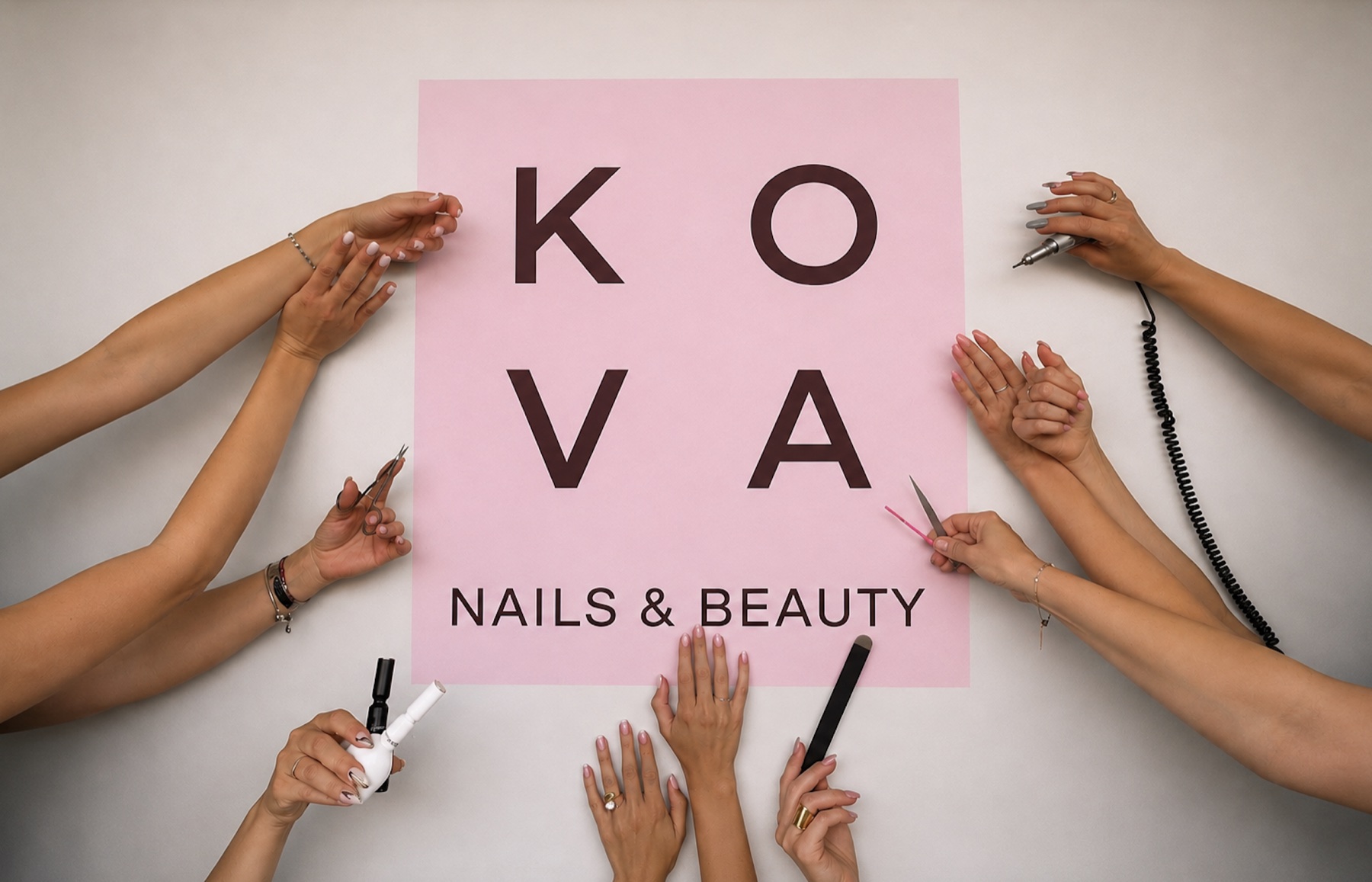Hands around the KOVA Nails & Beauty sign