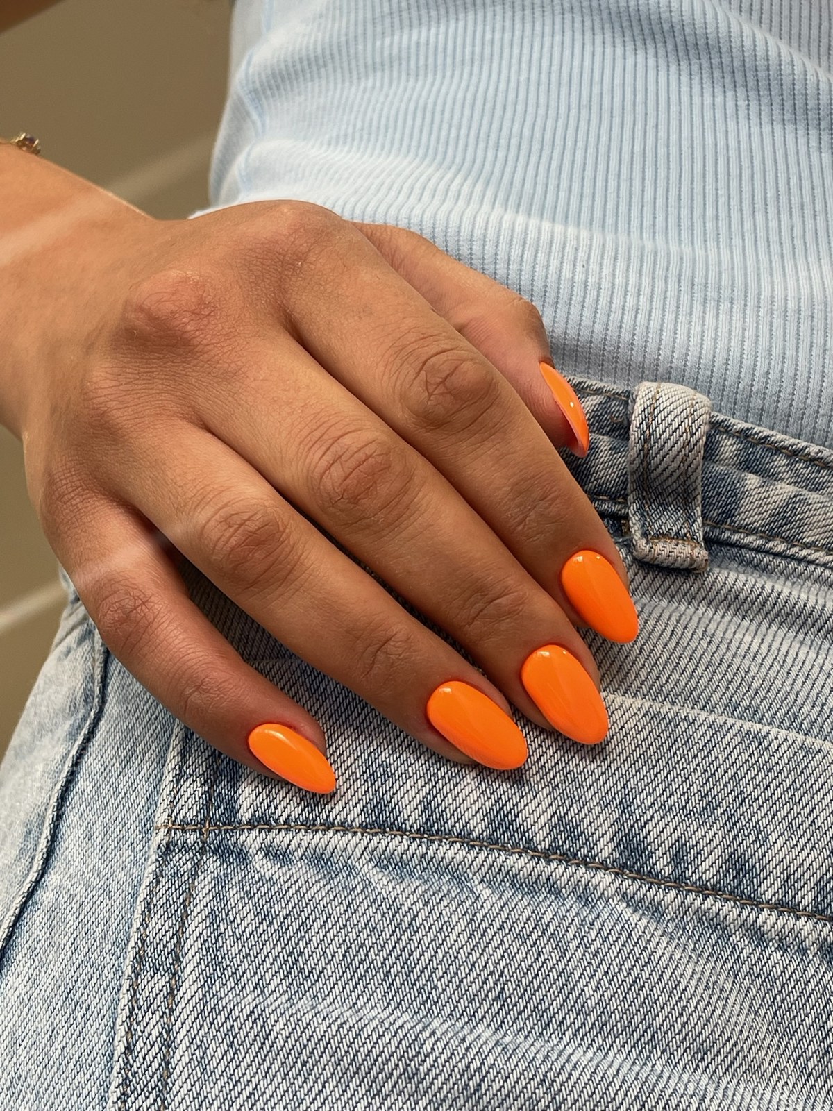 Neon orange glossy almond manicure