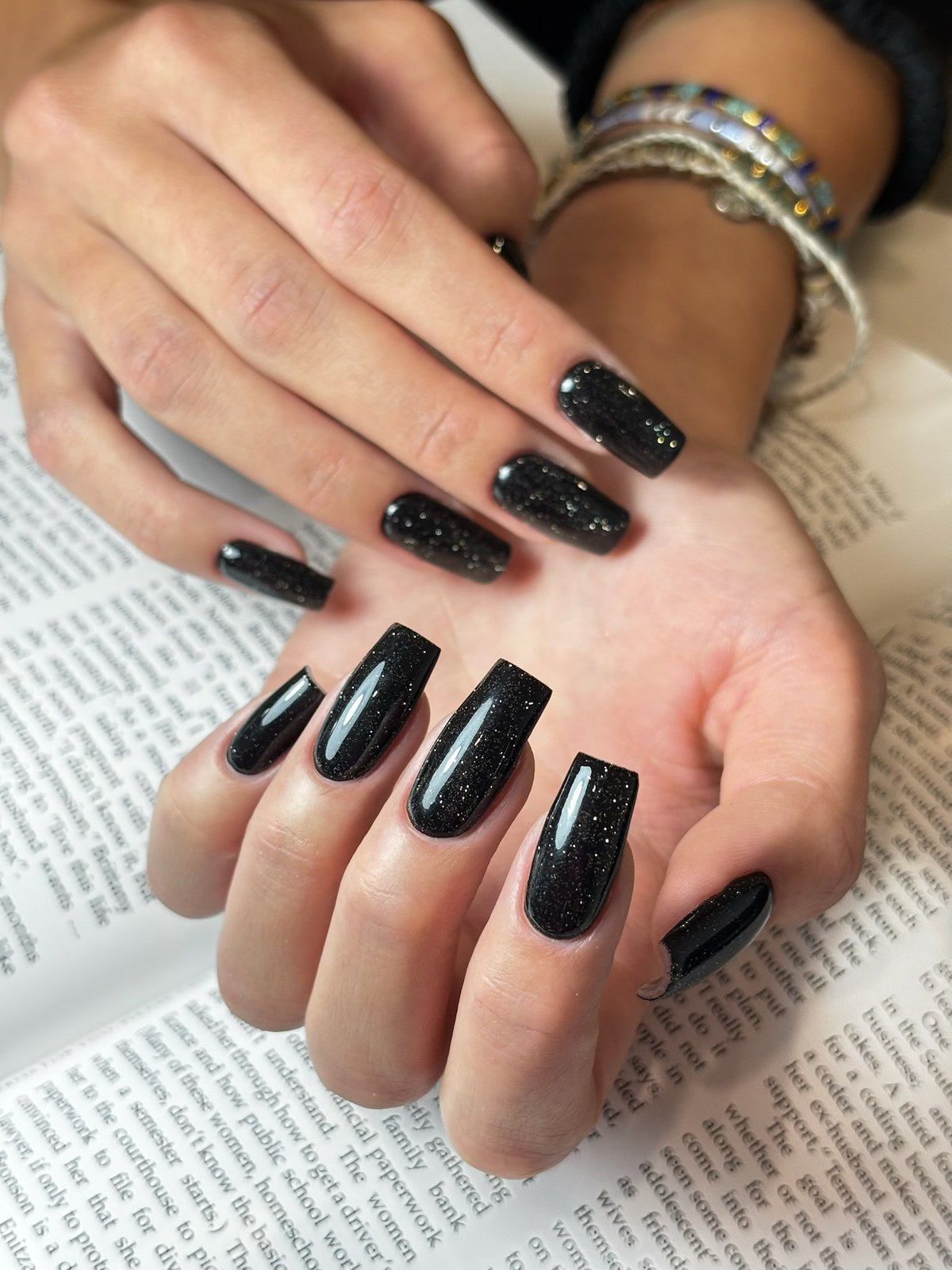 Black glitter coffin-shaped manicure