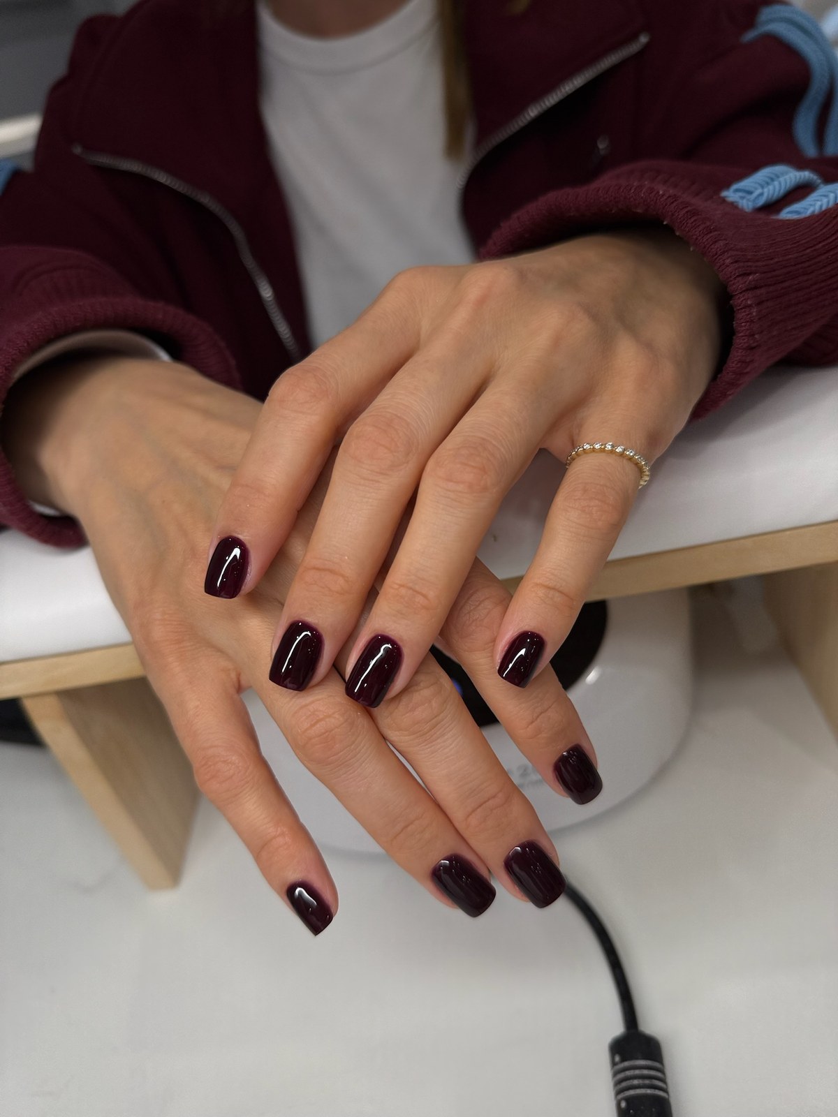 Deep burgundy-black glossy manicure