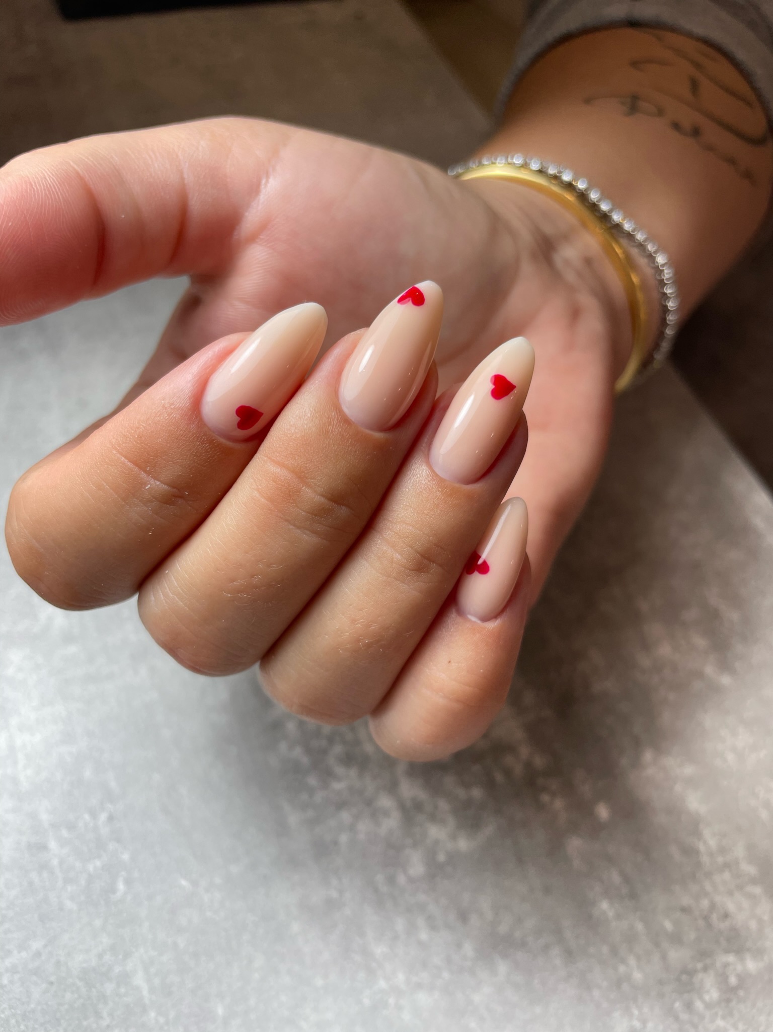 Nude manicure with heart nail art accent
