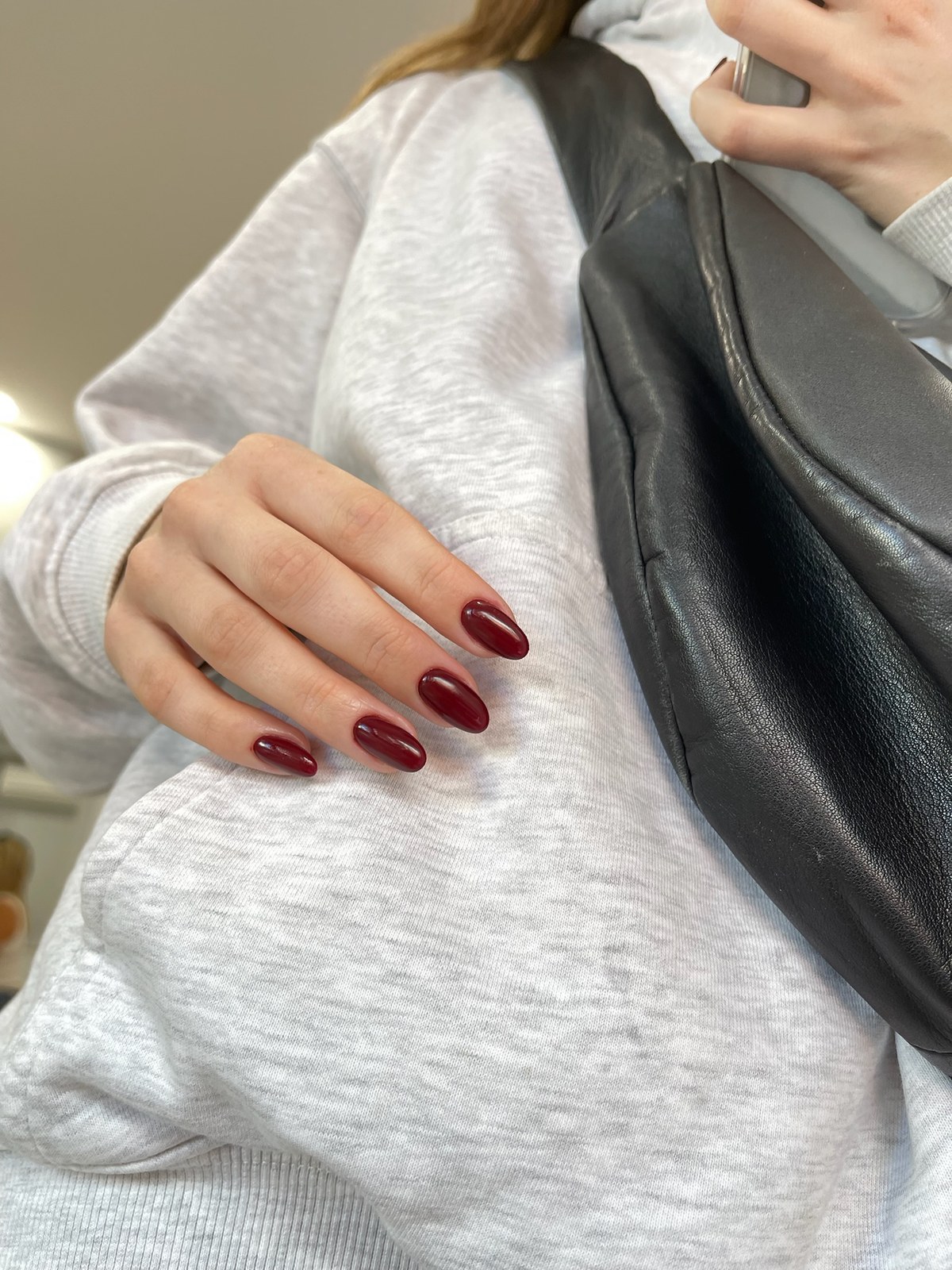 Deep burgundy glossy almond manicure