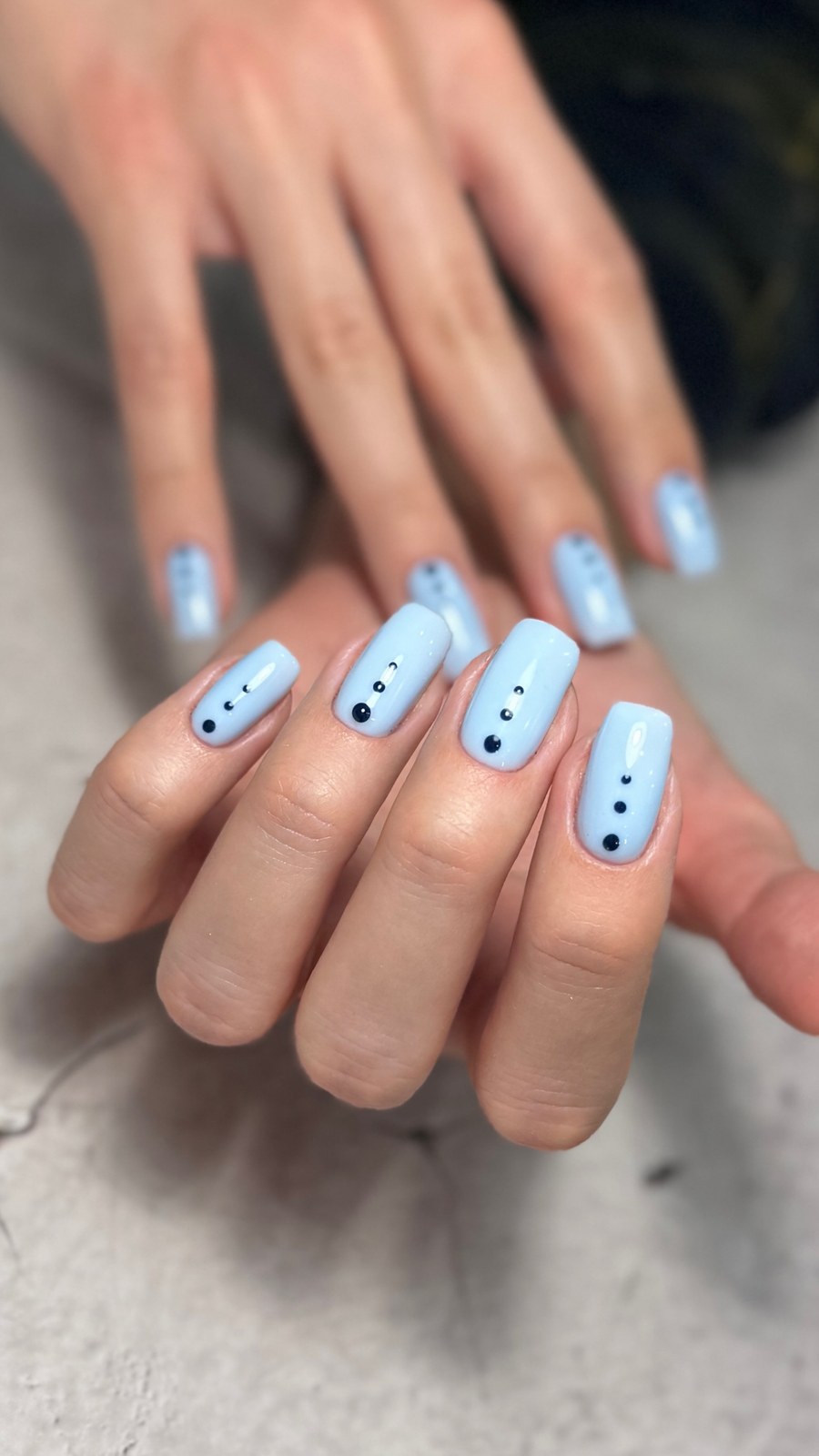 Pale blue nail art with dotted accent design