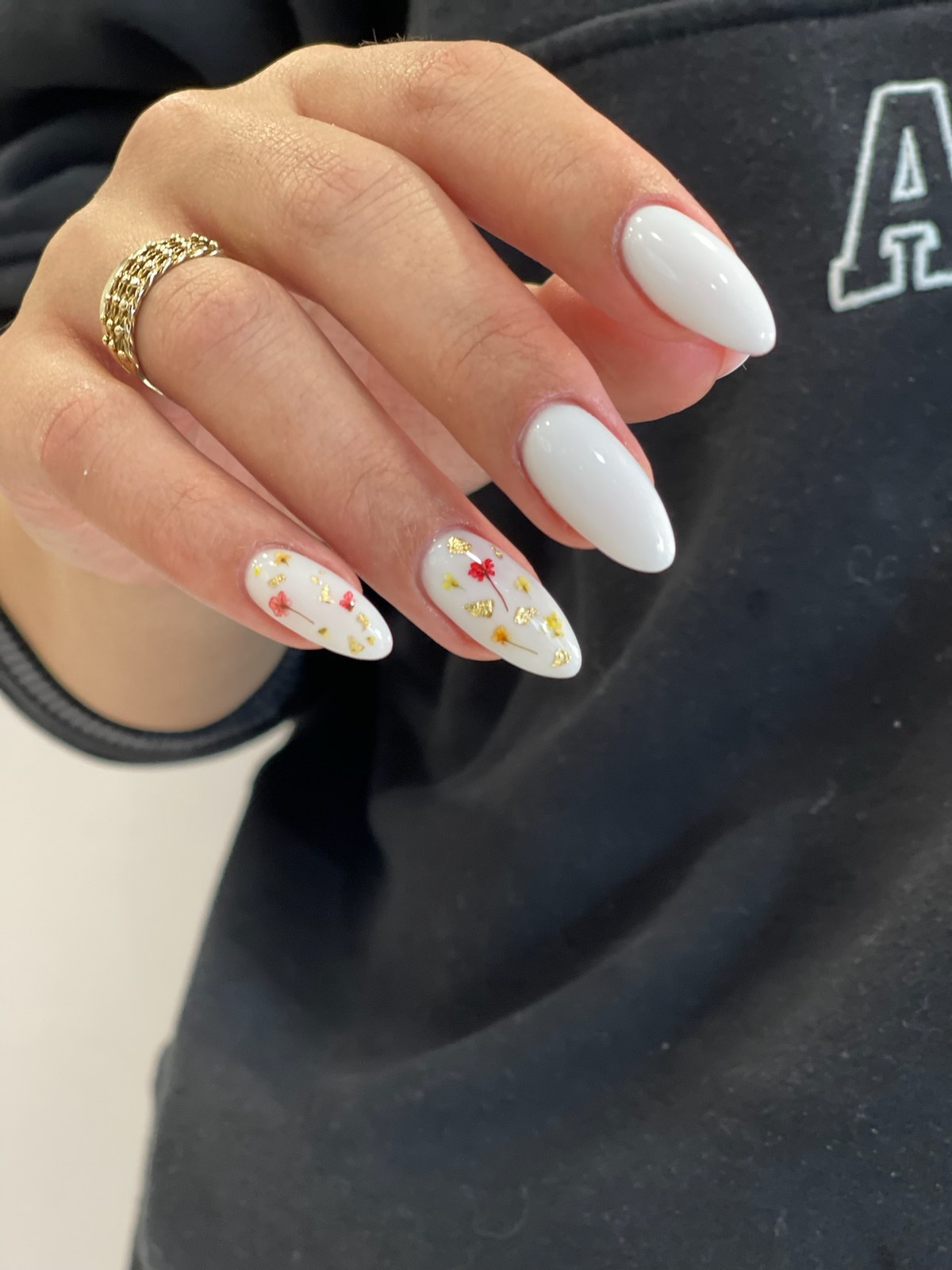 White manicure with tiny red heart nail art accents