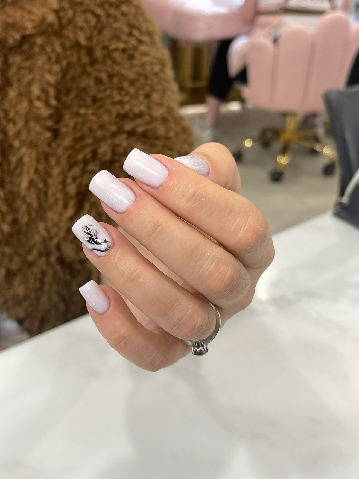 White manicure with hand-painted anchor nail art
