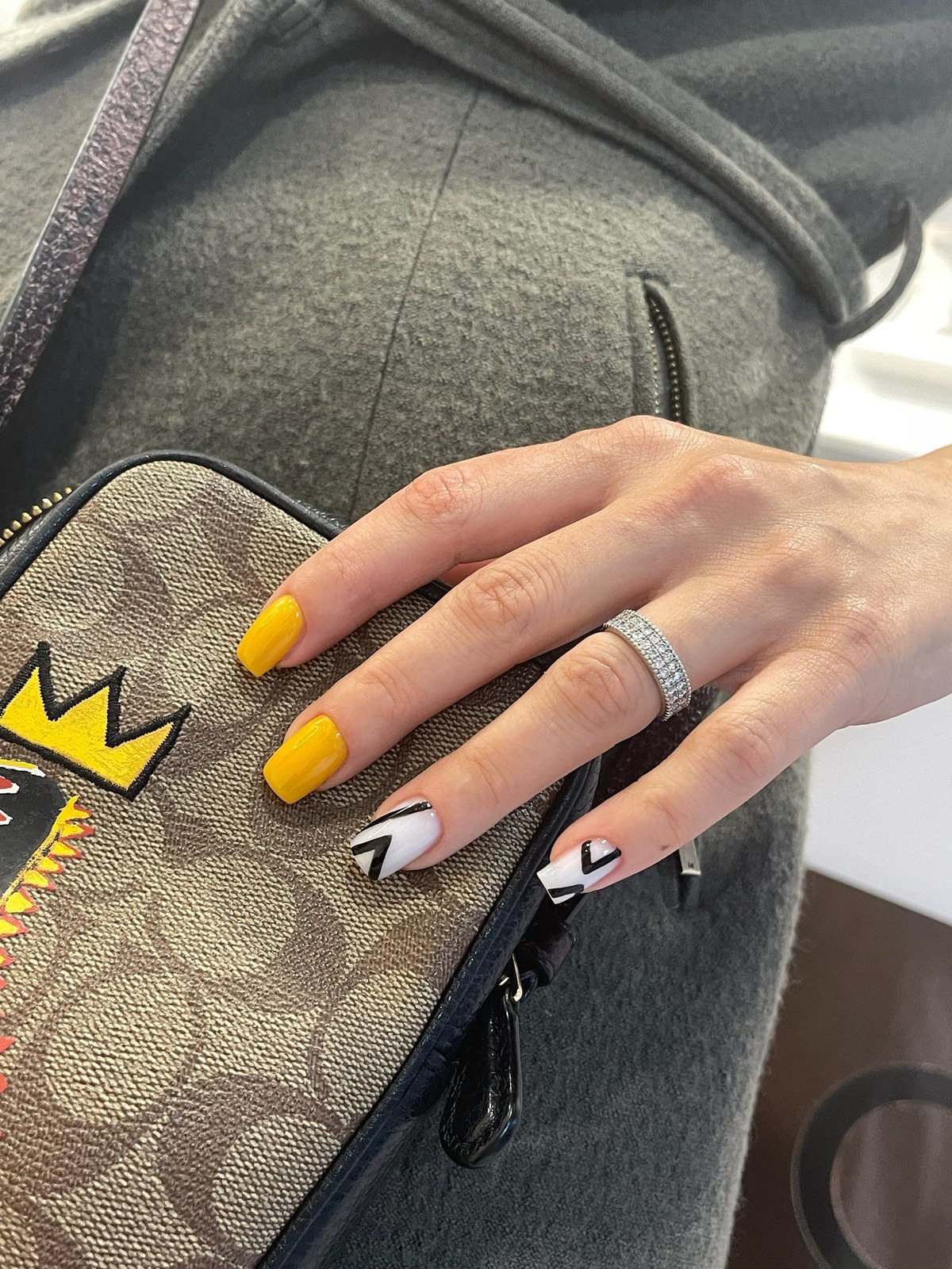 Yellow manicure with black and white graphic accent nails