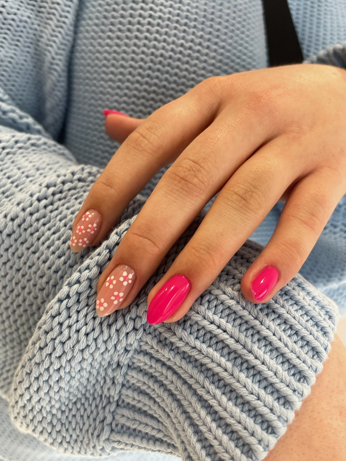 Pink manicure with white dot nail art accent