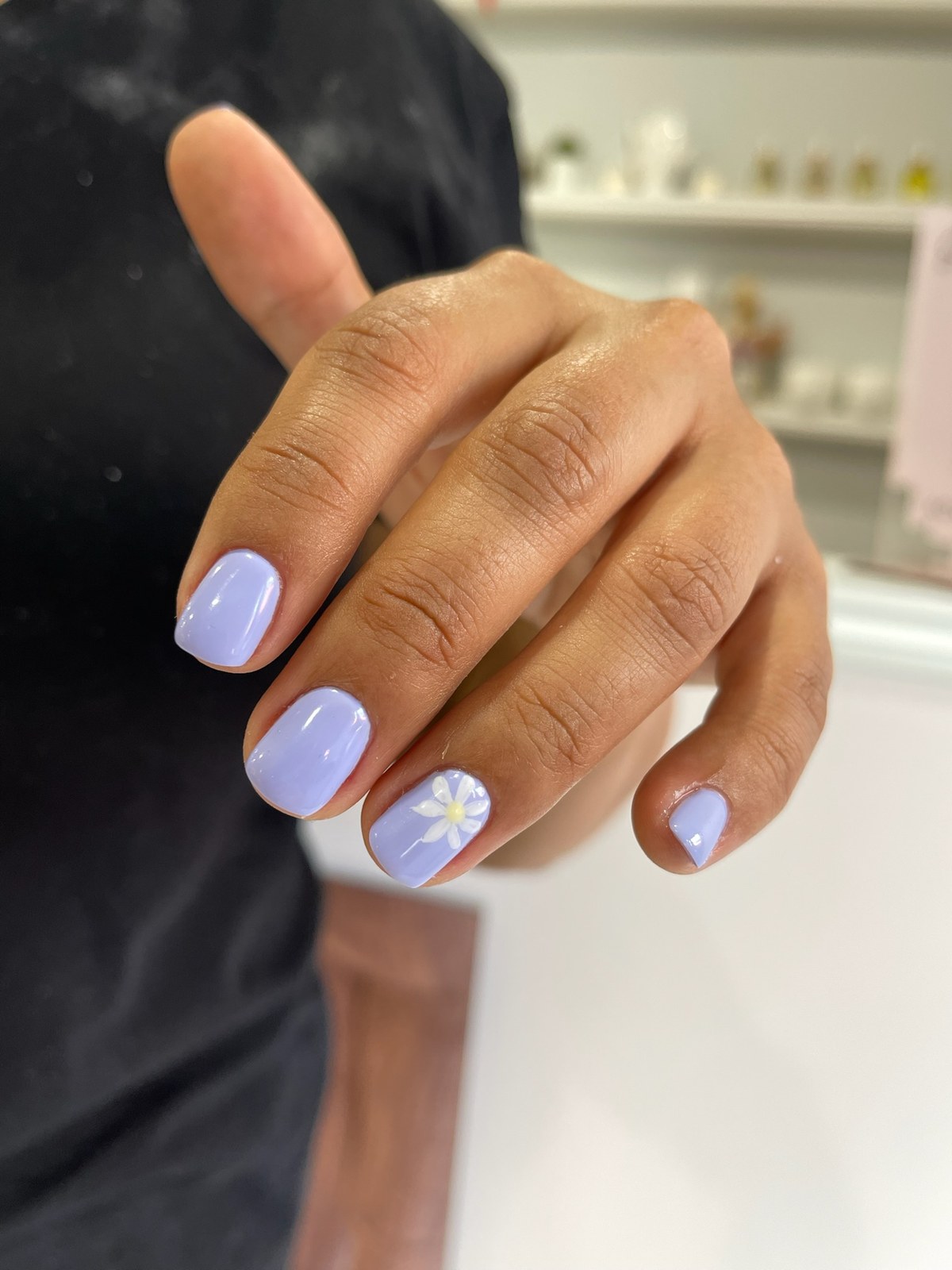 Lavender manicure with white flower nail art accent
