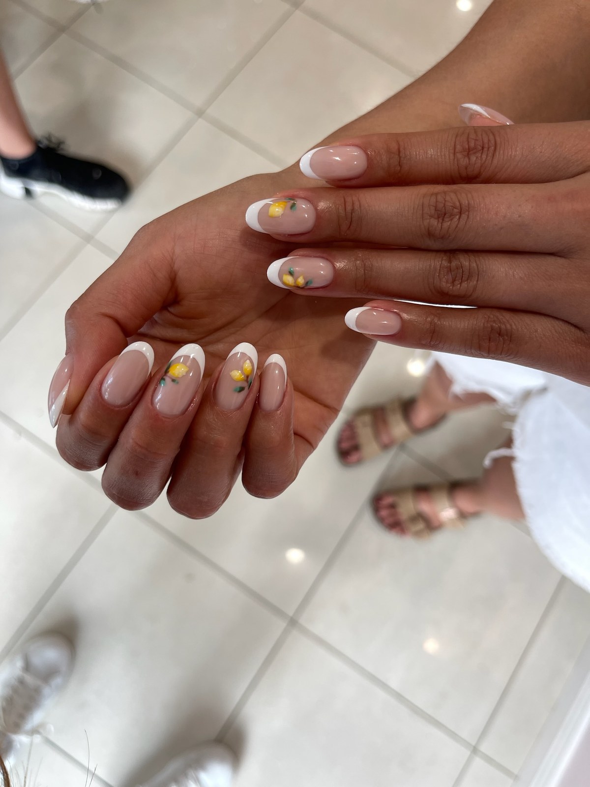 Nude manicure with yellow flower nail art accent