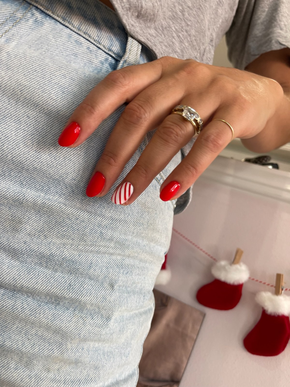 Red manicure with candy-cane striped accent nail