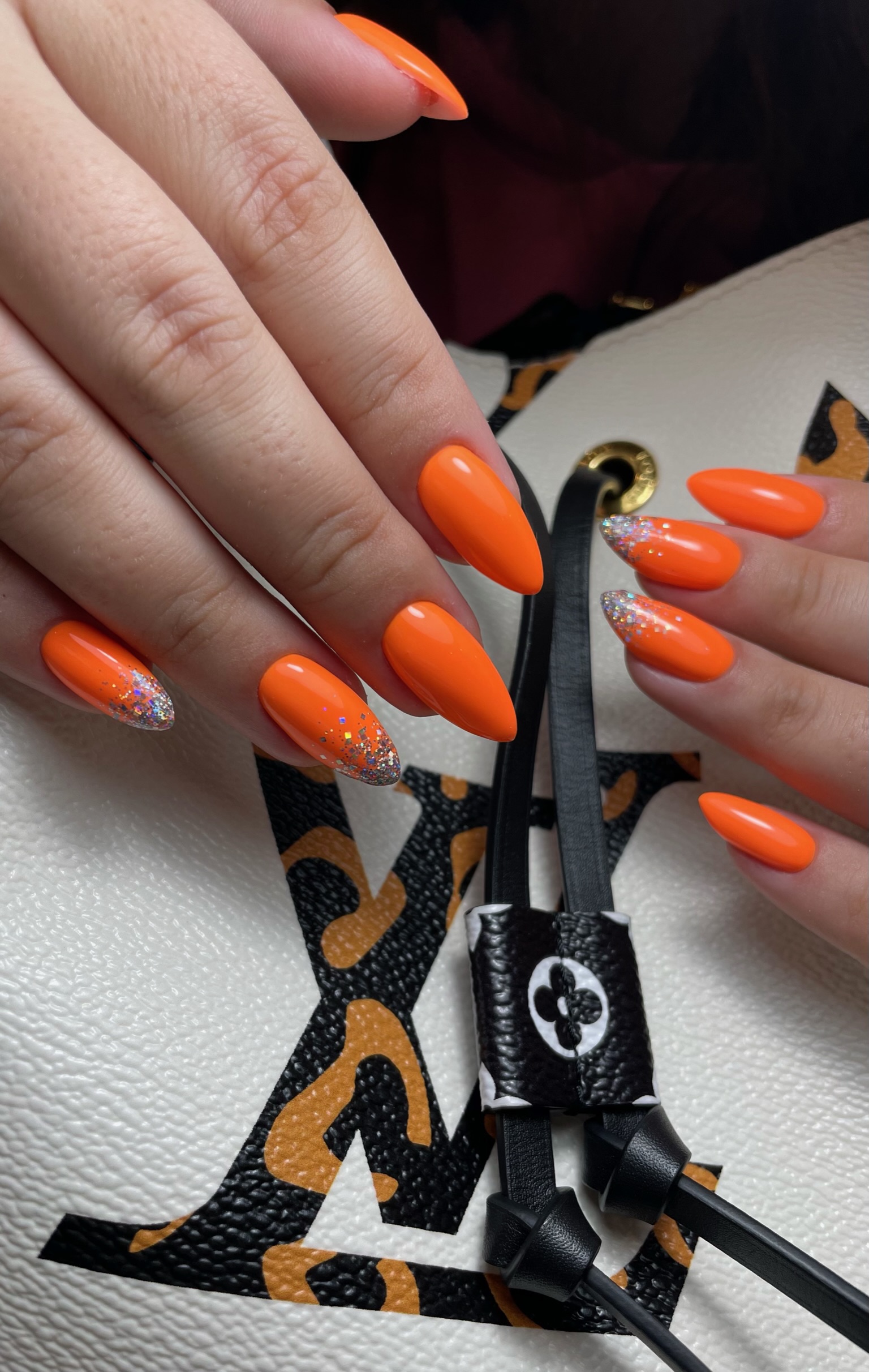 Bold orange glitter-tip nail art