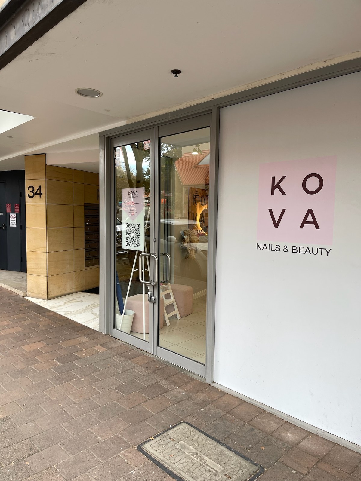 KOVA Nails & Beauty entrance signage close-up