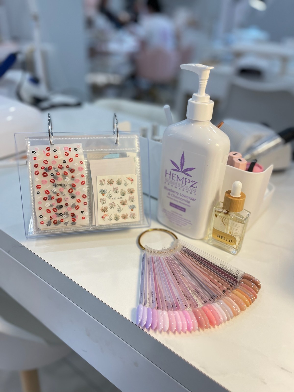 Gel colour swatch fan and cuticle care products on display