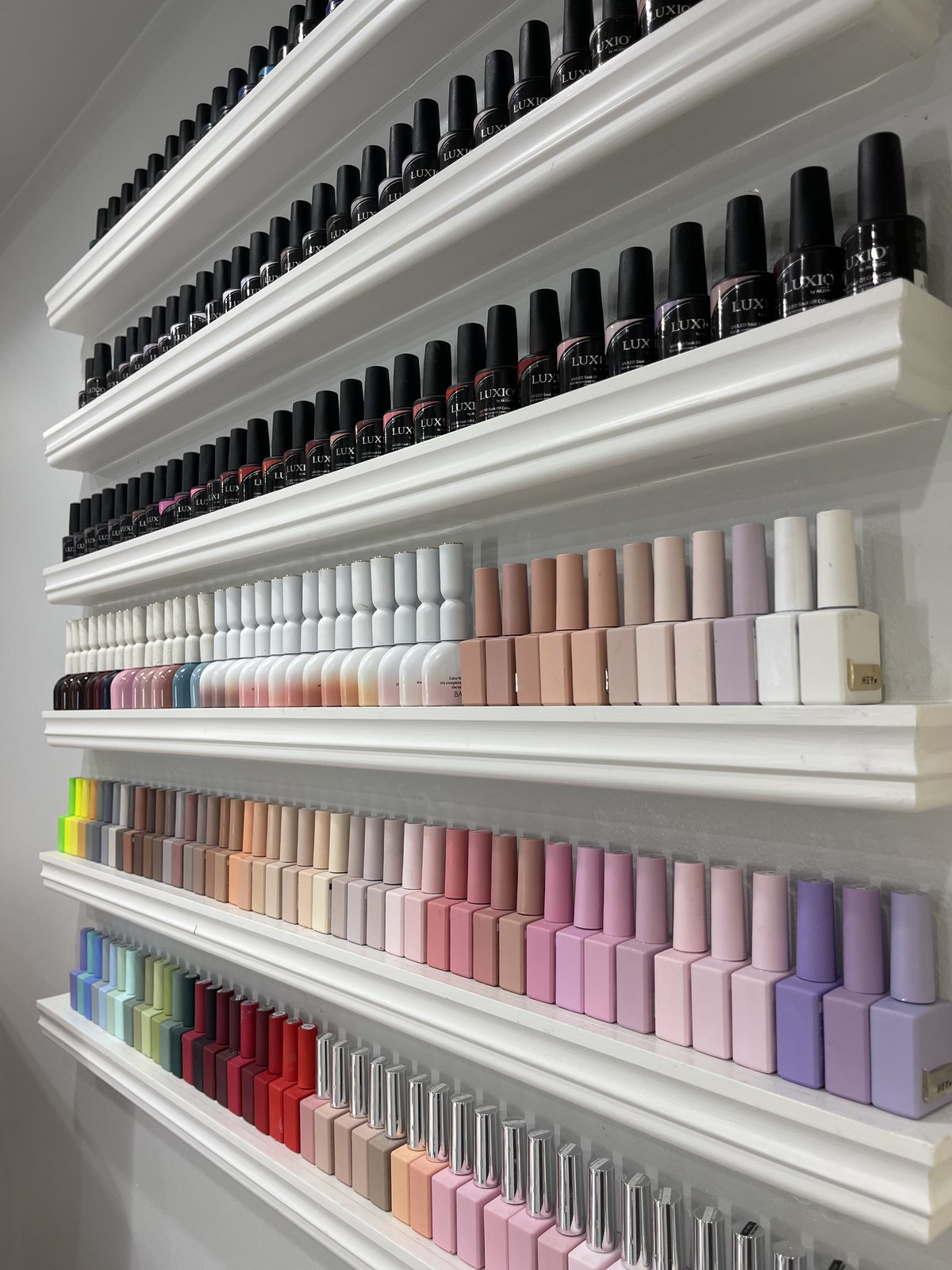 Wall display of rainbow gel polish color range
