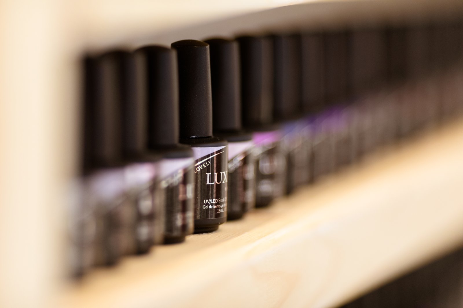 Shelf of professional-grade gel products used at KOVA